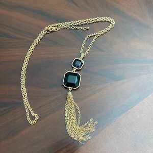 Gold necklace with black charm